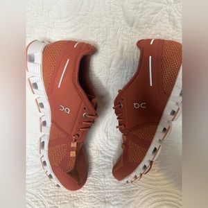 Burned orange ladies on cloud running shoes. Never worn